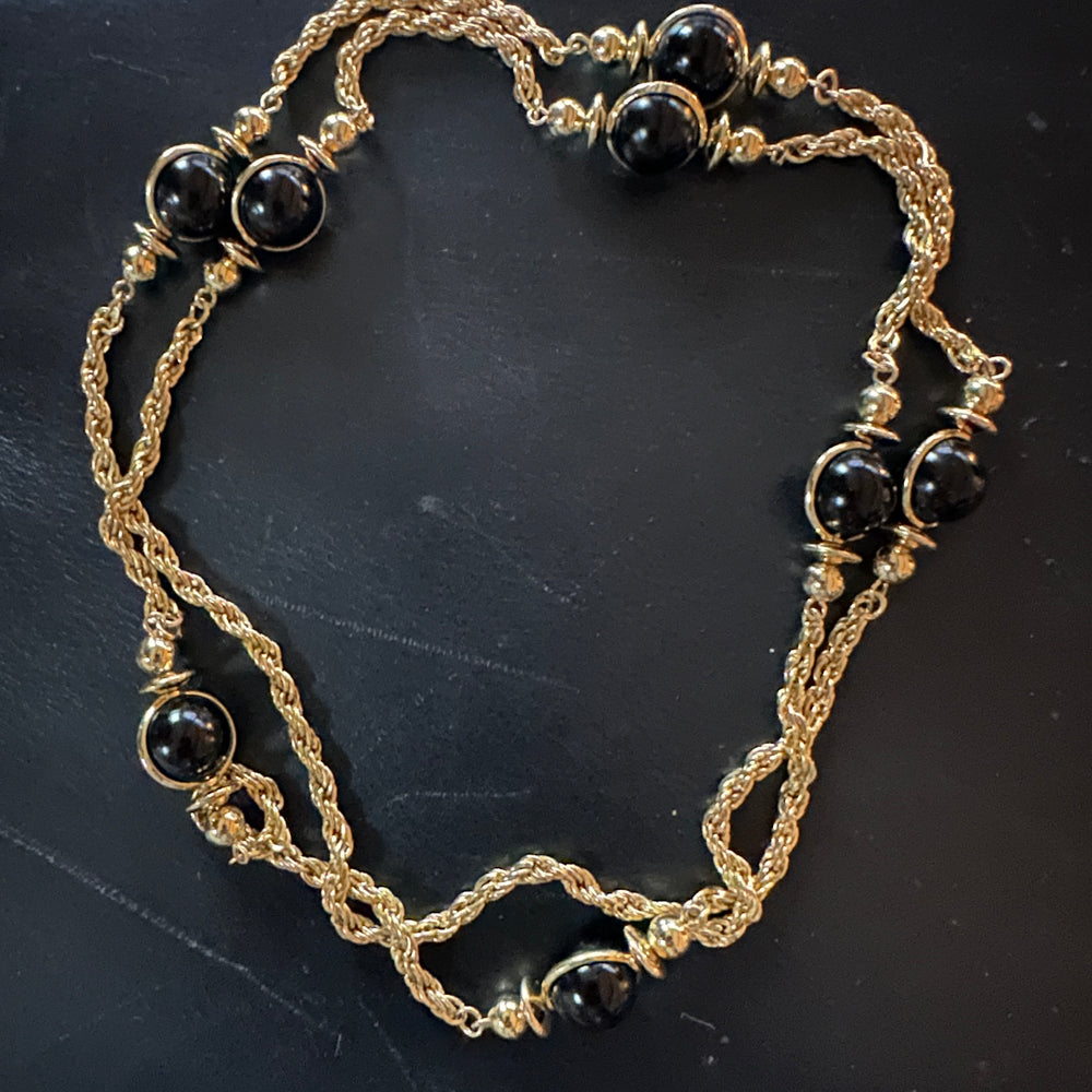 Long gold tone necklace with beads